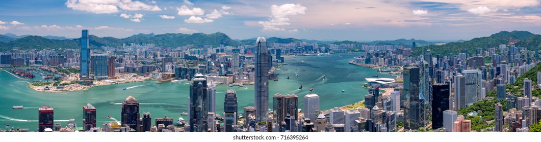 Wide Panorama Of Hong Kong Skyline From Victoria Peak On A Sunny Day