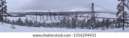 Wide panorama over the red high coast bridge in northern Sweden an overcast day in wintertime. Extremely high resolution. 