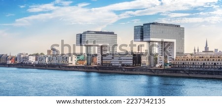 Wide panorama view of a Cologne cityscape skyline with Rhine river and modern residential buildings
