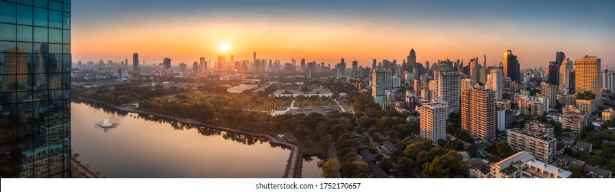 Wide Panoramic View of Bangkok, Thailand. Cityscape with Public Park and Skyscrapers at Sunset.