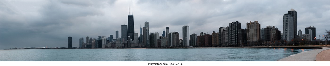 Wide panoramic view of Chicago skyline on a cloudy day, as seen from the Lakefront Trail.