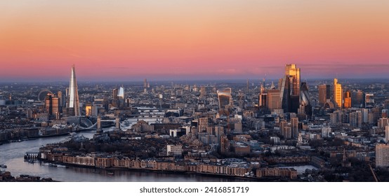 Wide panoramic view of the London skyline during dawn with pink colors and soft sunlight reflecting from the City skyscrapers, England - Powered by Shutterstock