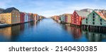 Wide panoramic view of old colorful wooden houses along river Nidelva in the Brygge district in Trondheim, Norway