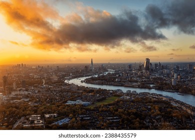 Wide panoramic view over the skyline of London, England, from Battersea along the River Thames until the City during a golden sunset