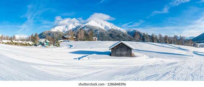 Wide panoramic view of winter landscape with snow covered trees and Alps in Seefeld in the Austrian state of Tyrol. Winter in Austria