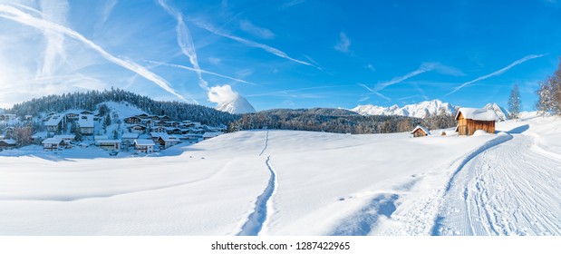 Wide panoramic view of winter landscape with snow covered trees and houses in Seefeld in the Austrian state of Tyrol. Winter in Austria