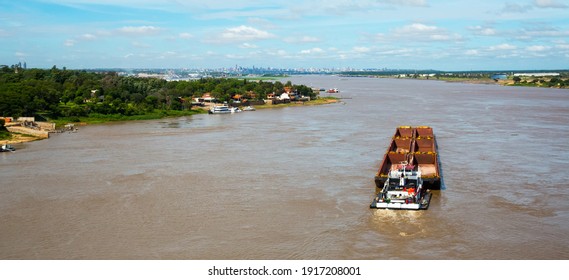 The wide Paraguay River with brown water in capital city Asuncion