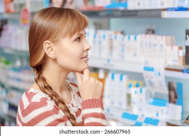 Wide Range Of Beauty Products. Young Attractive Woman Looking At The Shelves With Medications At The Pharmacy