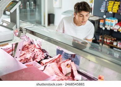 With wide range of fresh cuts on display, shopper makes his choice from assortment. - Powered by Shutterstock