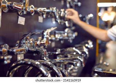 Wide Range Of Water Taps At A Modern Mall. Closeup Shot Of New Shiny Chrome Plated Faucets At A Hardware Store Or Shopping Centre. Soft Focus, Blurred Background. Retail, Shopping Concept