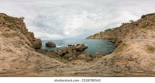 A wide rocky coastline with crashing waves and cloudy skies captured in a 360-degree view, creating an immersive coastal scene. The rugged terrain adds depth to the natural landscape. - Powered by Shutterstock