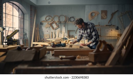 Wide Shot of an Artisan Furniture Designer Reading Blueprint and Starting to Assemble Legs of a Wooden Chair. Stylish Carpenter Working in a Studio in Loft Space with Tools on the Walls. - Powered by Shutterstock