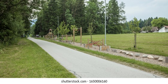 A Wide Shot Of A Bike Road And A Playground Near Tall Trees