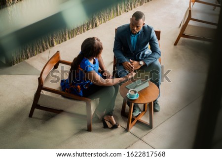 Wide shot business meeting consultation by black african financial adviser.
