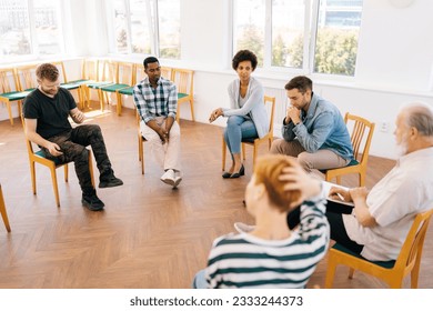 Wide shot of community, support and psychology with diverse and different ages people in workshop for teamwork, mental health or empathy. Human resources, communication or team building. - Powered by Shutterstock