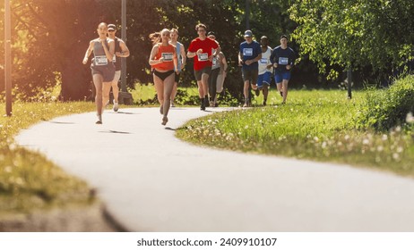 Wide Shot of Diverse Marathon Participants Competing in a Race for the Finish Line: Group of People Running Through Park Health Trail and Participating in a Marathon with Dedication - Powered by Shutterstock