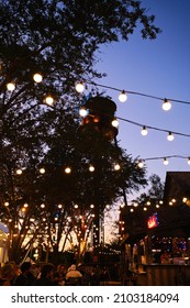 Wide Shot Of Hanging Light Bulbs In Outdoor Terrace, Warm Light Source . Vertical Shot