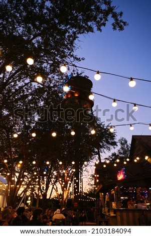 Wide shot of Hanging light bulbs in outdoor terrace, warm light source . Vertical shot