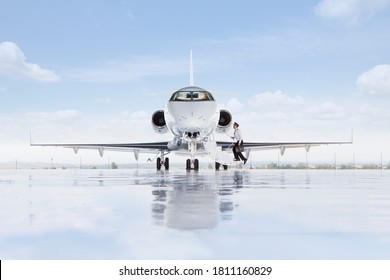 A Wide Shot Of Pilot Boarding A Private Jet On A Runway.