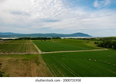 Wide Shot Taken From The Top Of The Ile De La Madeleine Observation Deck Focussing On The River And Mountains