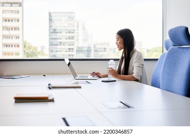 Wide Shot Of Young Woman Working In Modern Office