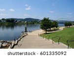 Wide steps lead down to the river walk along the Ohio River in Wheeling, West Virginia on a summer day, looking north toward the bridge to Ohio.