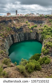 Wide View Of The Big Hole In Kimberley, A Result Of The Mining Industry, With The Town Skyline On The Edge