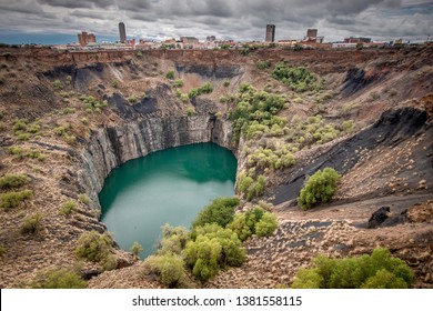 Wide View Of The Big Hole In Kimberley, A Result Of The Mining Industry, With The Town Skyline On The Edge