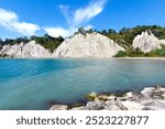 Wide view of the cliffs at Bluffers Park in Toronto known as the Scarborough Bluffs with Lake Ontario in the foreground.