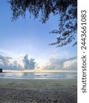 Wide view of cloudscape at the beach during sunrise