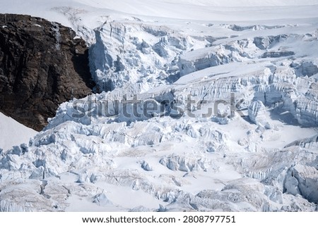 Wide view of a dramatic alpine icefall carved by deep crevasses and continuous ice movement. The fractured surface illustrates the powerful forces shaping high mountain glaciers and provides an impressive example of active glacial dynamics.