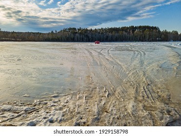 Wide View Of Ice Covered Norton Pond In Lincolnville Center Maine With An Old Camper As A Fishing Shack In The Winter.