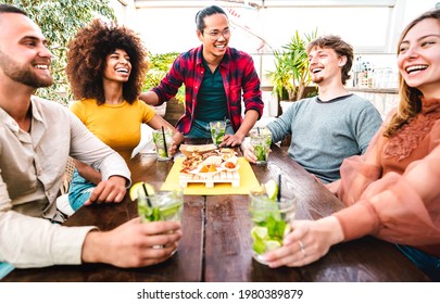 Wide View Of People Group Drinking Mojito At Fashion Cocktail Pub Restaurant - Party Time Concept With Young Friends Having Fun With Fancy Drinks On Happy Hour At Bar - Focus On Central Asian Guy