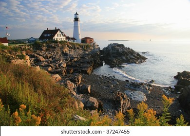 Wide view of the Portland Head Light House and wildflowers at dawn - South Portland, ME