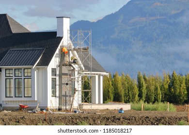 Wide View Of Professional Builders Busy Completing An Addition Or Extension For A Modern Home. 