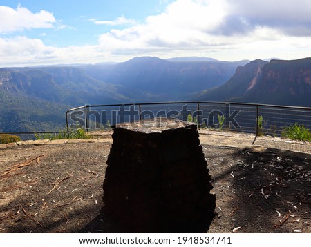 Wide view of the valley from Evans Lookout, taken from behind brick pedestal, blue haze cast over mountains, Grand Canyon Bushwalk, Blackheath, Blue Mountains, NSW, Australia