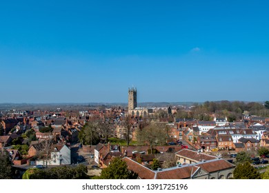 Wide view of Warwick town in England’s West Midlands region. The Collegiate Church of St. Mary is in focus with its tower