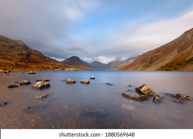 Wide vista view of remote lake Wastwater with dramatic sky. Lake District, UK. - Shutterstock ID 1880569648