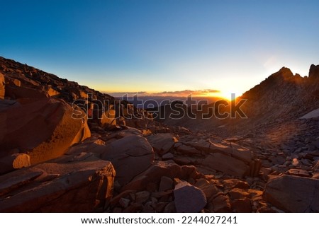 Wide-angle panorama of early morning sunrise in silhouetted boulder field - Maroon Bells-Snowmass Wilderness, Colorado, USA