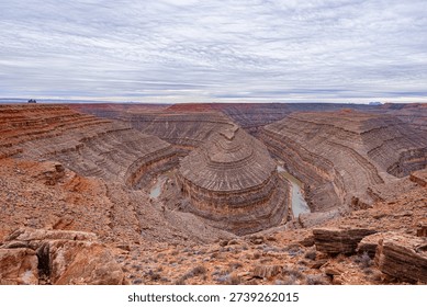 A wide-angle, panoramic view of the deep, winding entrenched meanders of the San Juan River carved into the desert landscape at Goosenecks State Park,