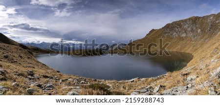 A wide-angle shot of a lake in the mountains, perfect for backgrounds