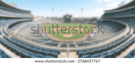 A wide-angle view of an empty baseball stadium, showcasing the meticulously maintained green field, the iconic diamond, and rows of blue seating under a bright, clear sky.