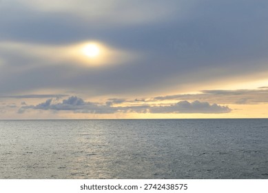 A wide-angle view of the sunset over the open waters of the Vestfjorden, captured from the deck of the ferry traveling from Bodø to Moskenes.