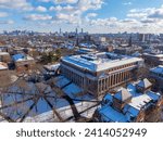 Widener Library aerial view in winter at Old Harvard Yard with Boston skyline at the back in historic center of Cambridge, Massachusetts MA, USA. 