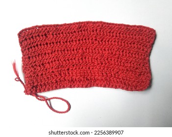 Wider crotchet stich due to adding unnecessary chain or chaining the basic chain too tight. Crotchet mistake example. Simple mistake beginner di in crocheting. Red wider crotchet square isolated.