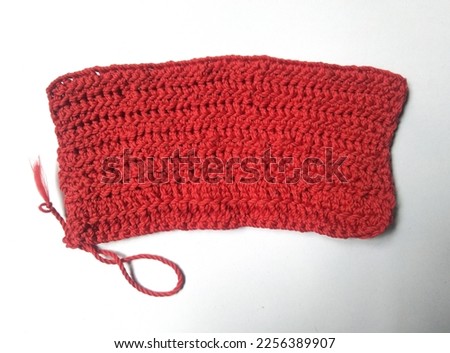 Wider crotchet stich due to adding unnecessary chain or chaining the basic chain too tight. Crotchet mistake example. Simple mistake beginner di in crocheting. Red wider crotchet square isolated.