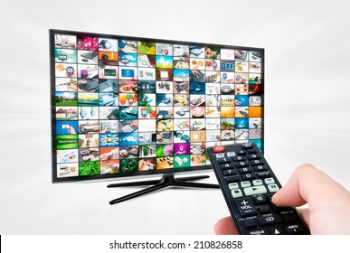 Widescreen High Definition TV Screen With Video Gallery. Remote Control In Hand