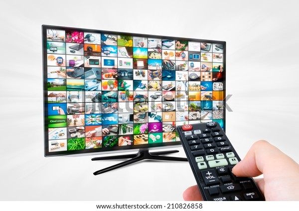 Widescreen high definition TV screen with video\
gallery. Remote control in\
hand