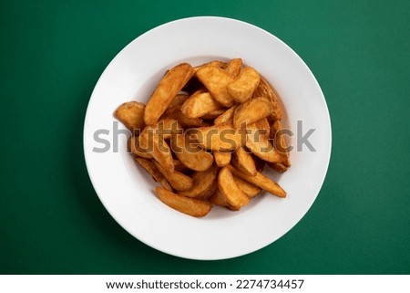 Widget potatoes in wind blade on green background