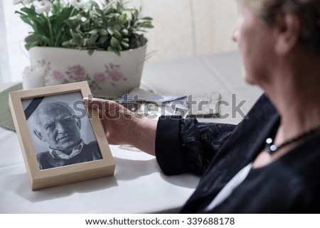 Widow looking at the photo of her dead husband